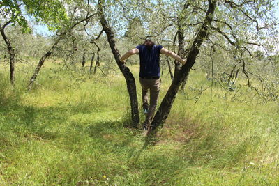 Man standing on field in forest