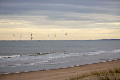 Scenic view of beach against sky during sunset