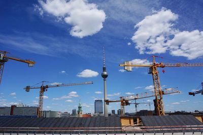 Cranes at construction site against sky in berlin.