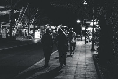 Woman in illuminated city at night