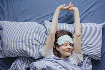 High angle view of woman lying on bed