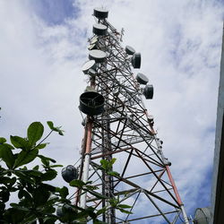 Low angle view of communications tower against sky