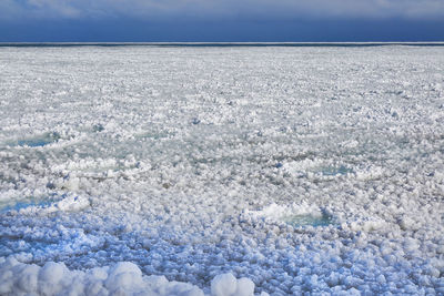 Scenic winter view of  ice and snow along chicago lakefront against sky