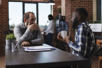 Business colleagues talking at office