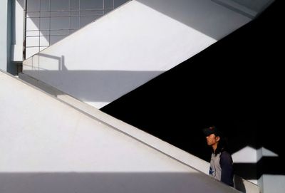 Low angle view of man standing on staircase