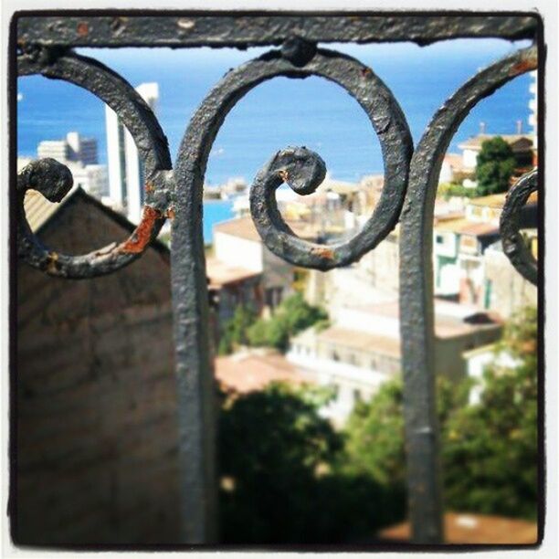 transfer print, metal, auto post production filter, close-up, metallic, fence, focus on foreground, protection, safety, rusty, railing, security, built structure, day, architecture, chainlink fence, gate, sky, padlock, no people