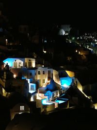 Close-up of illuminated cityscape against sky at night