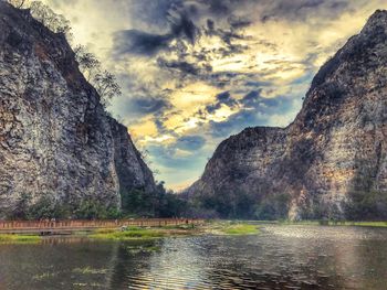 Scenic view of lake by mountains against sky