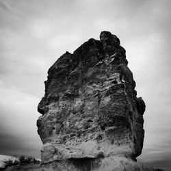 Low angle view of rock formation against sky