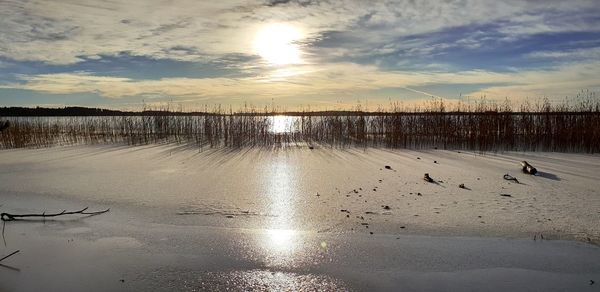 Scenic view of lake against sky during sunset