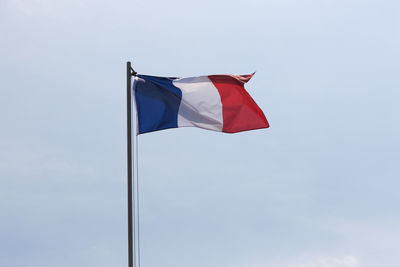 Low angle view of flag against sky