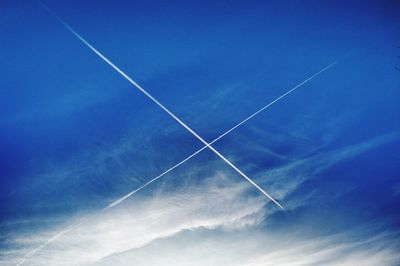 Low angle view of vapor trails in sky