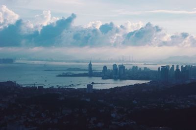 View of cityscape against cloudy sky