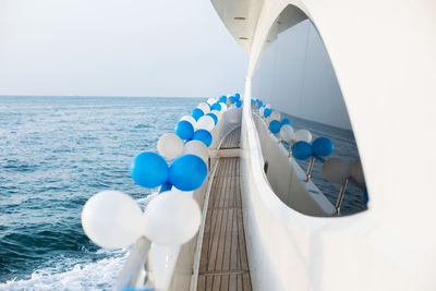 The exterior of a luxury yacht decorated with balloons. event, holiday, birthday