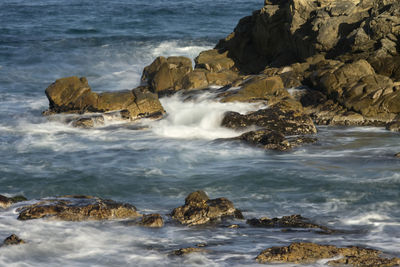 Sea waves splashing on rocks