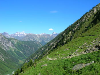 Scenic view of mountains against clear blue sky