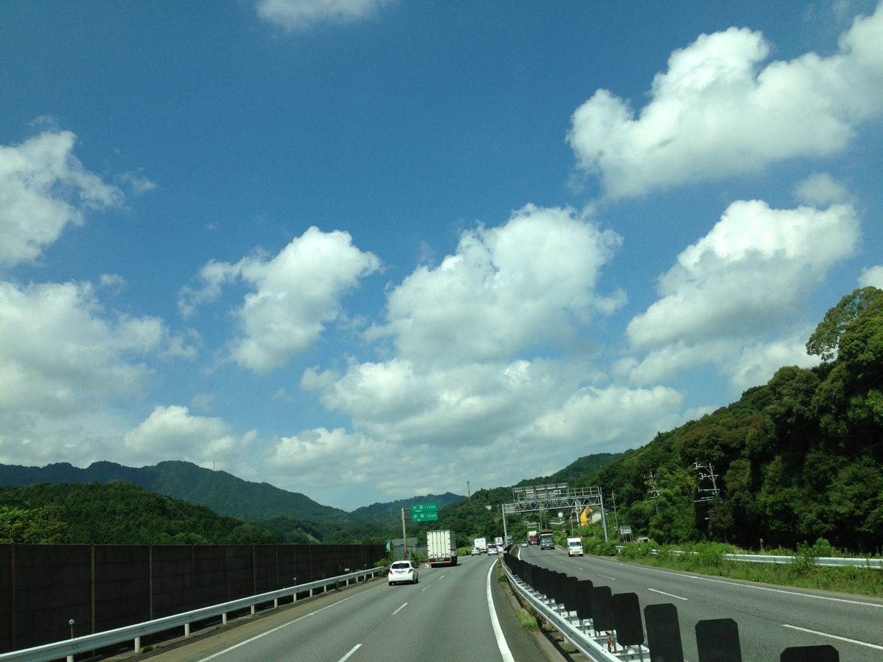 transportation, road, mountain, sky, the way forward, cloud - sky, car, road marking, mountain range, diminishing perspective, cloud, highway, land vehicle, vanishing point, cloudy, mode of transport, nature, scenics, country road, beauty in nature