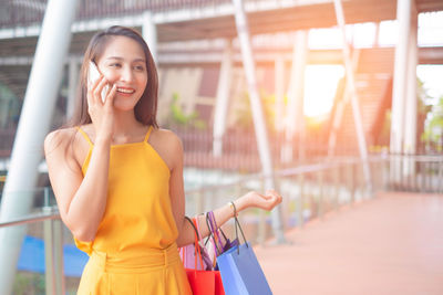 Young woman using mobile phone outdoors