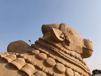 Low angle view of statue against sky