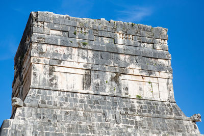 Low angle view of old building against blue sky