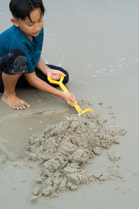 High angle view of boy playing on beach