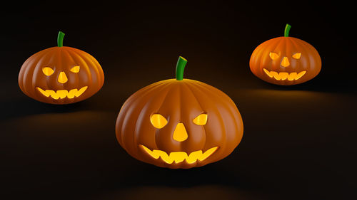 Illuminated pumpkin against black background