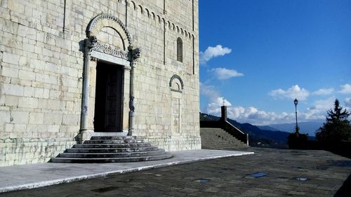 Cross in temple against sky