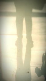 Shadow of woman standing on hand