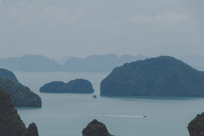 Scenic view of sea and mountains against sky