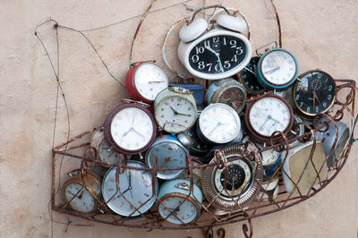 High angle view of old clocks in container