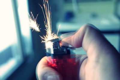 Cropped image of person holding illuminated light bulb