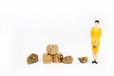 Man with toy standing against white background