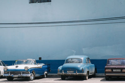 Cars on road against blue sky