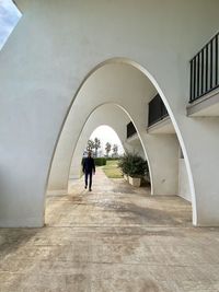 Rear view of man walking in building