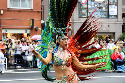 Full length of woman holding umbrella on street