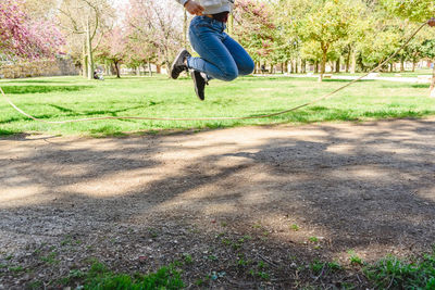 Low section of man jumping in park