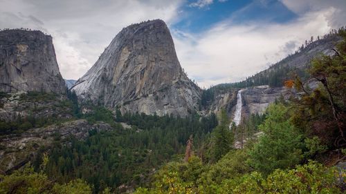 Scenic view of mountains against cloudy sky
