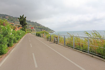 Road by mountain against sky