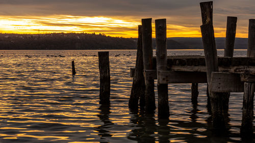 Pier over lake during sunset