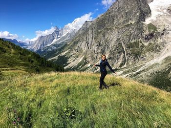 Full length of a man on landscape against mountain range
