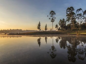 Scenic view of lake against sky at sunset