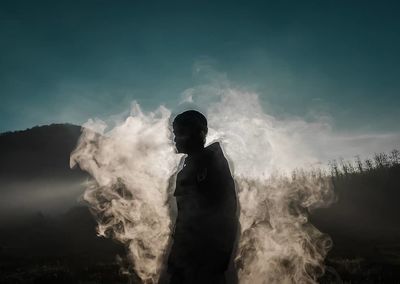 Silhouette man standing against sky