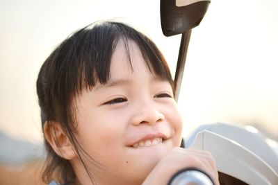 Close-up of smiling girl looking away