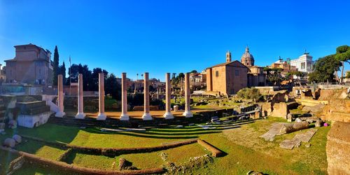 Panoramic view of buildings against clear blue sky