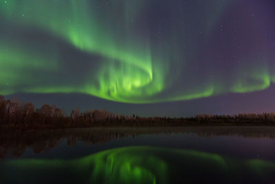 Scenic view of lake against sky at night