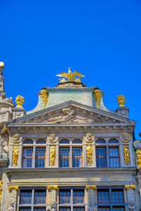 Low angle view of building against blue sky