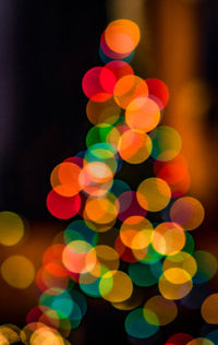 Defocused image of illuminated christmas lights at night