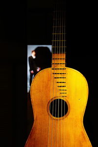 Close-up of guitar against black background