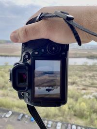 Close-up of person photographing camera