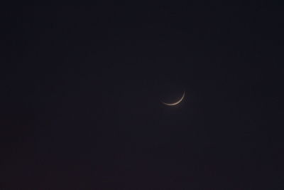 Low angle view of moon against sky at night